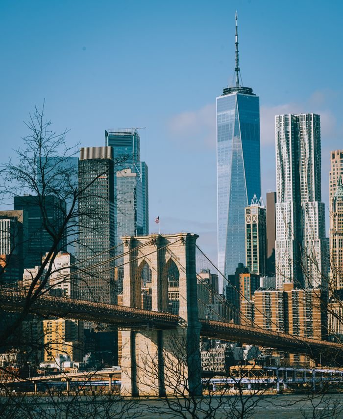 Iconic Brooklyn Bridge and New York City's skyline featuring One World Trade Center.